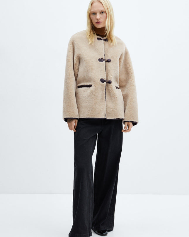 Faux fur coat with applications