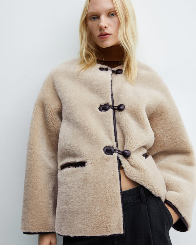 Faux fur coat with applications