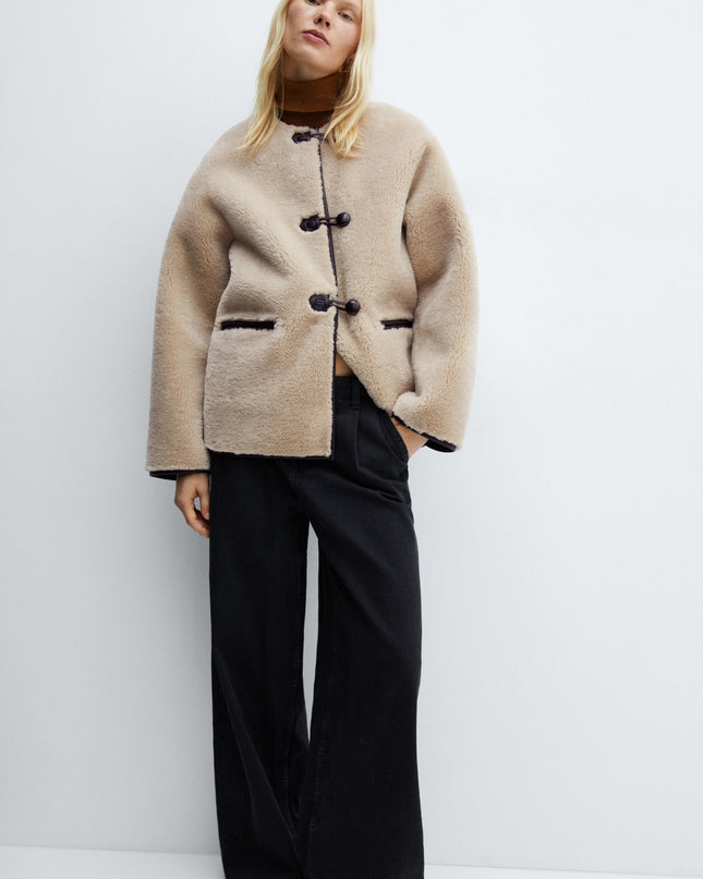 Faux fur coat with applications