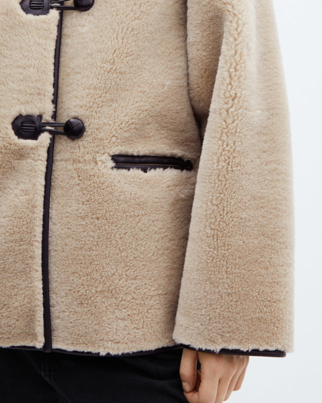 Faux fur coat with applications