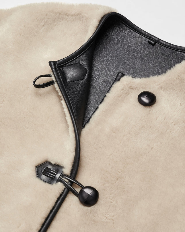 Faux fur coat with applications